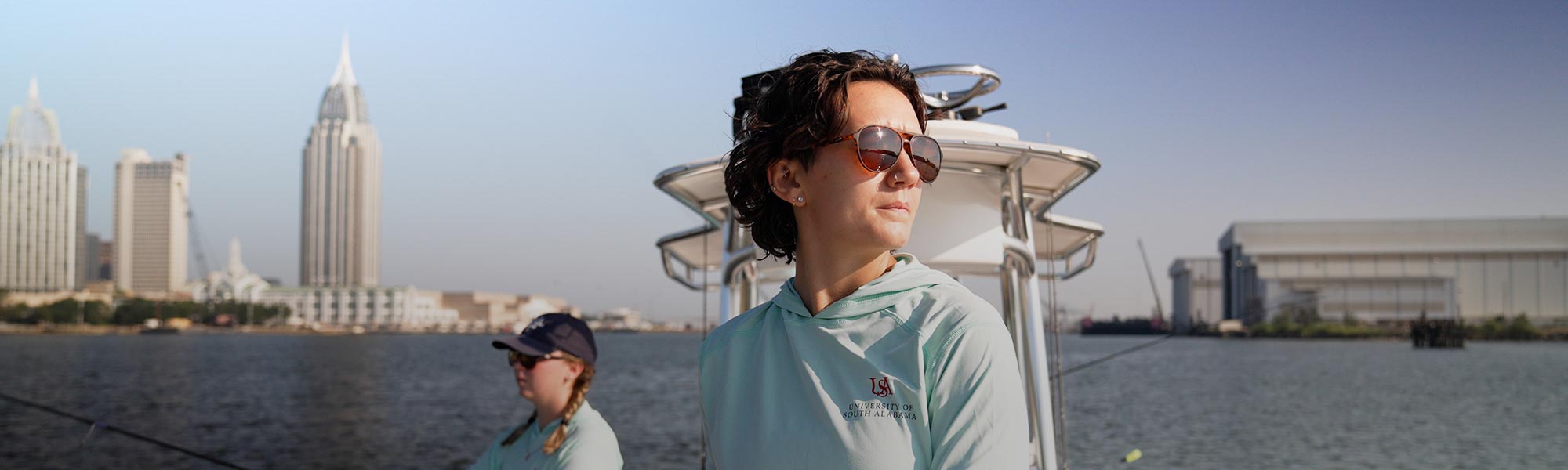 Marine sciences students with the city skyline in the background