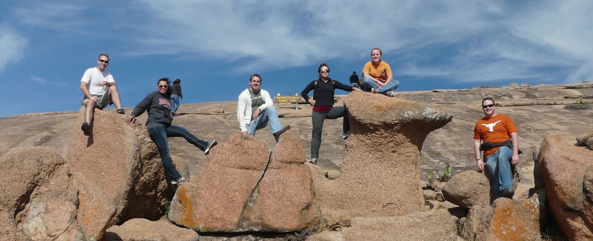 Class on a field trip posing on rocks