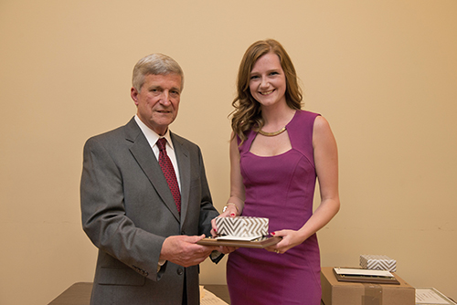 Robyn King is congratulated by Dr. Bill Williams.