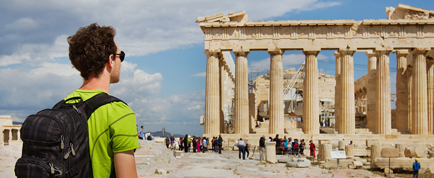 Student in Greece sightseeing with backpack on. 
