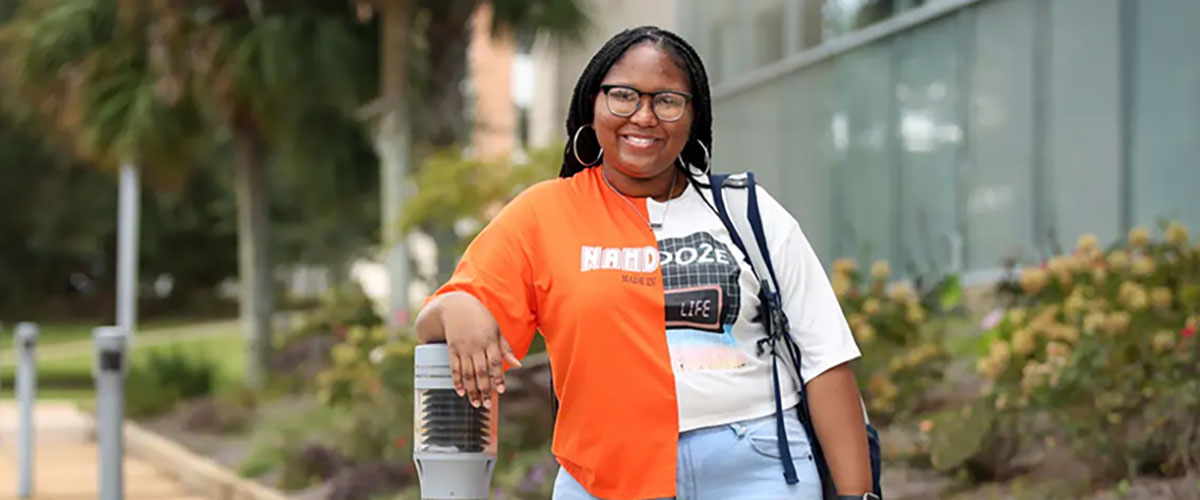 Female student standing outside of the library.