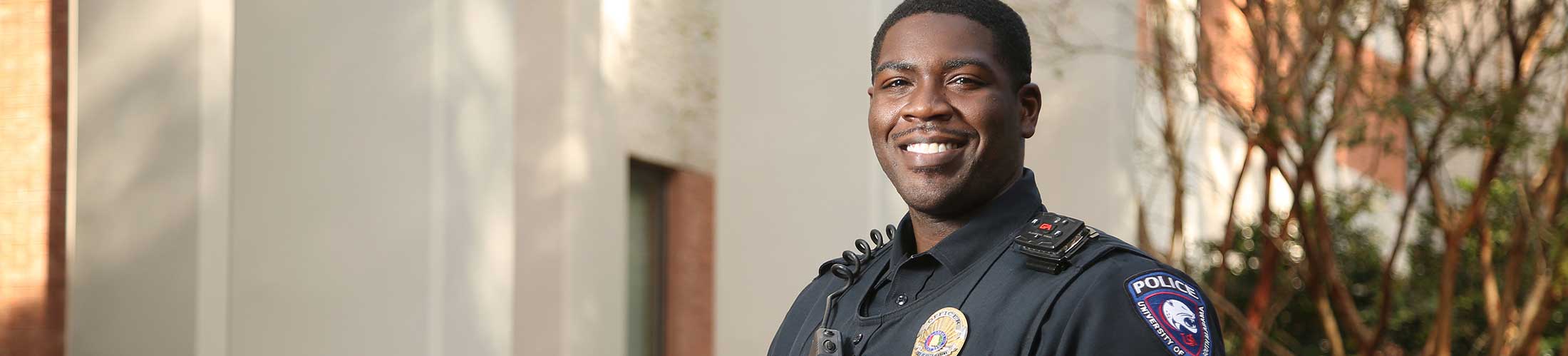 South Alabama police officer smiling outside.