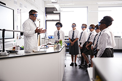 Students in a lab watching teacher.
