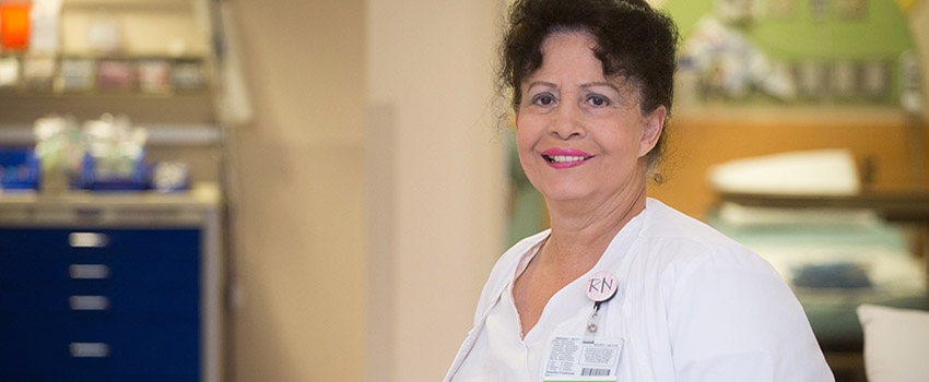 Nurse smiling inside hospital