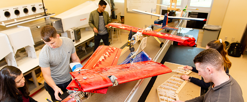 Mechanical Engineering students working on planes