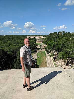 Dr. Doug Marshall in front of ruins in Mexico