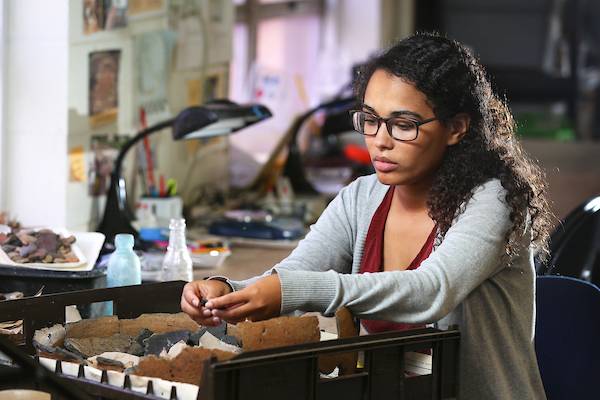 Female student working in lab on fossils.