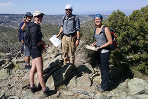 Students and professor working in the field for geology