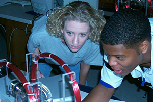 Two physics students working on project.