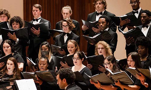 Students perfoming in the choir singing.