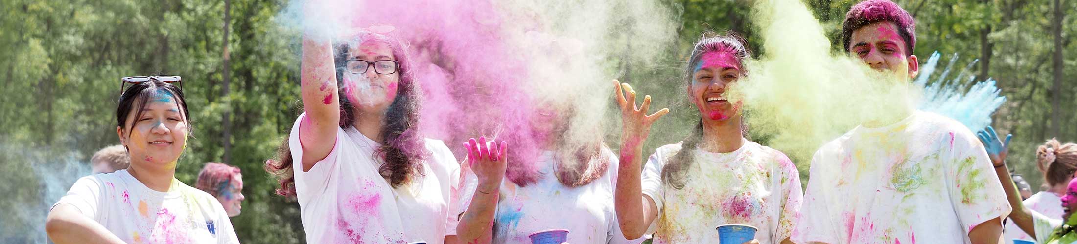 Students throwing up color at holi fest.