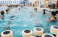 Group in pool doing water aerobics.