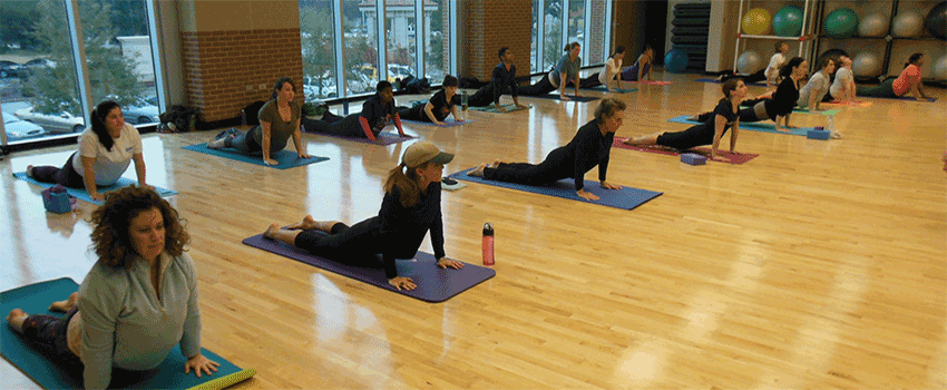 Students stretching in group class at rec center.