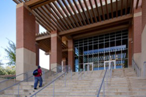Student walking up stairs of student rec center.