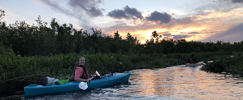 Female student in kayak in water