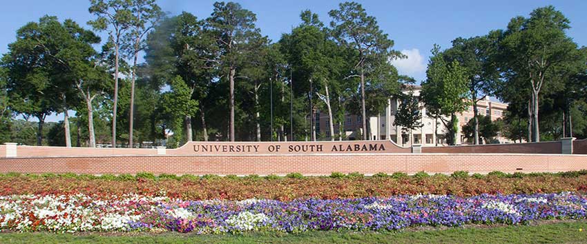 University of South Alabama street sign with flowers.