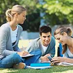 Student sitting on grass studying