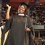Graduate smiling and waving