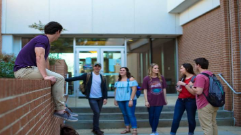 Group of six students talking outside