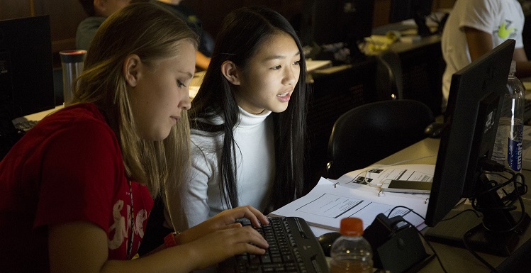 Emily Martin, left, and Tu Anh, work on encryption assignments during GenCyber Camp held at USA's School of Computing. They and other rising 9th Graders at Davidson High School participated in the week-long program. data-lightbox='featured'