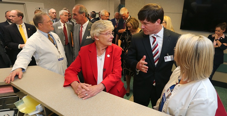 Gov. Kay Ivey, center, tours the University of South Alabama Medical Center and talks with Sam Dean, hospital administrator, before announcing a $4 million bond issue to renovate and expand the hospital’s Level 1 Trauma Center. data-lightbox='featured'