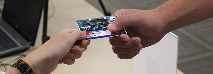 individual handing jagcard to another person to complete a transaction