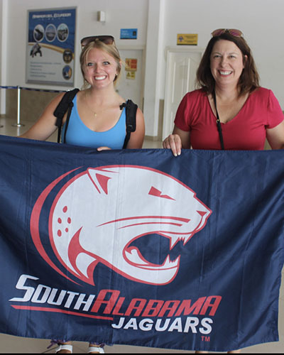 Two Women Holding South Alabama Flag
