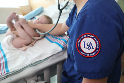 USA Nurse checking baby's heart.