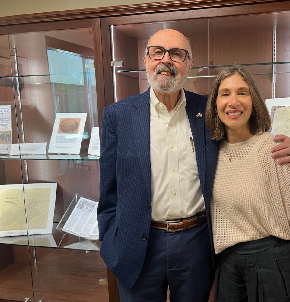 Collection Donor Larry Voit stands with McCall Library Director Deborah Gurt in front of the Claiborne exhibit.