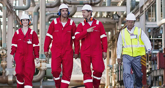 Workers walking in construciton hats on site.