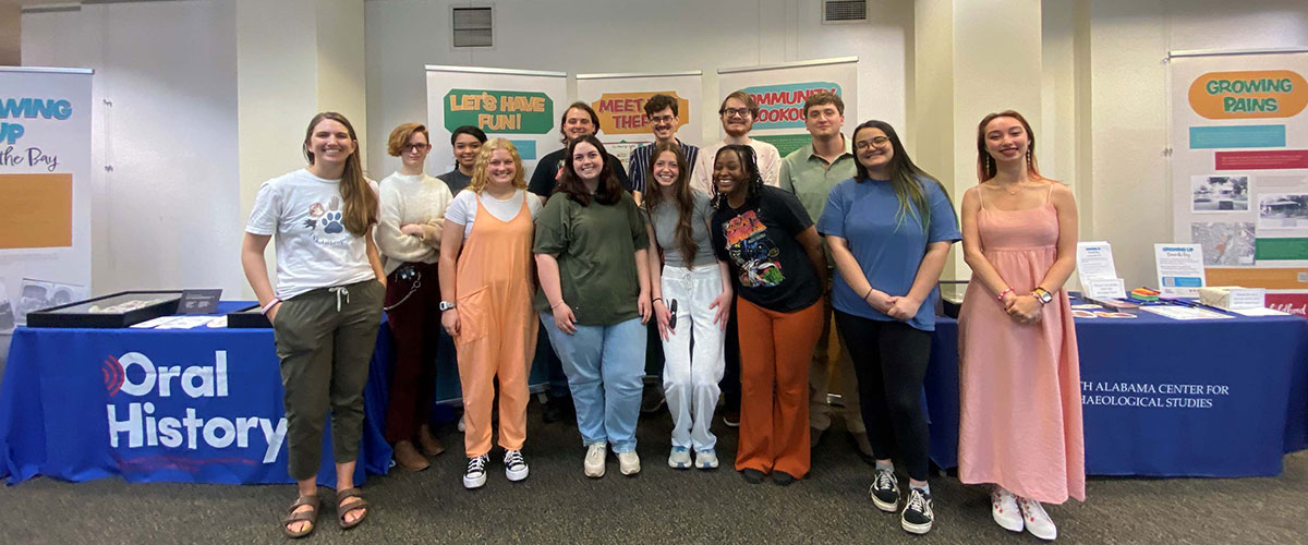 group of students stands in front of banners